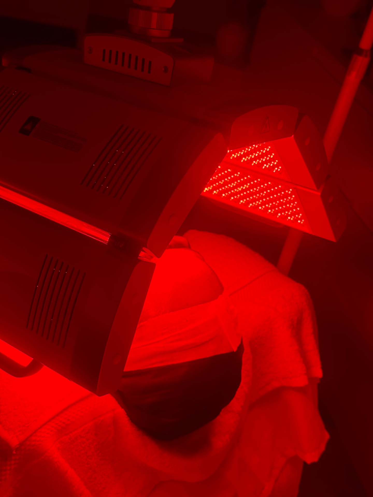 Client receiving red LED light therapy at Alura Skin Studio