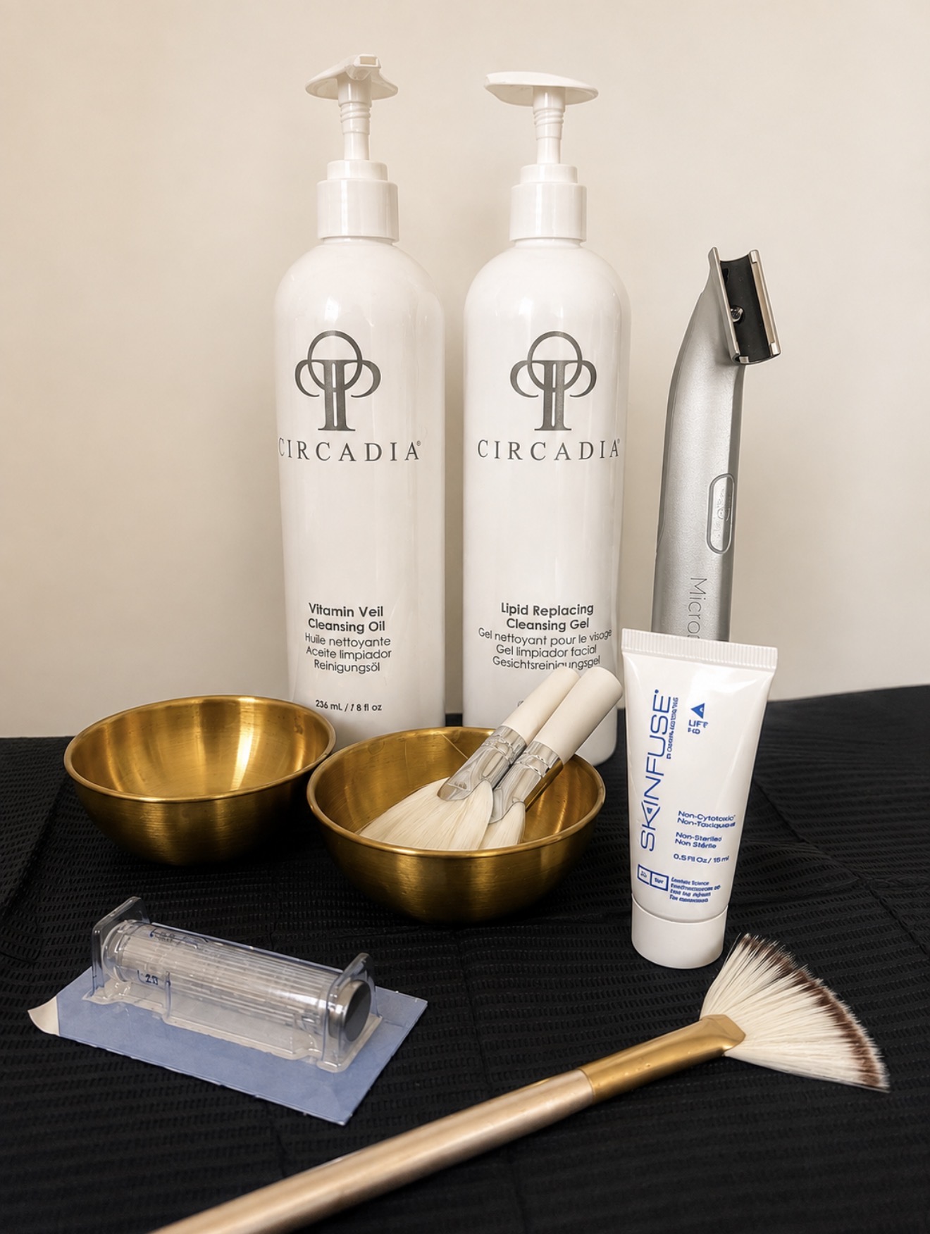 Professional cleansers, brushes and microneedling pen set up for treatment