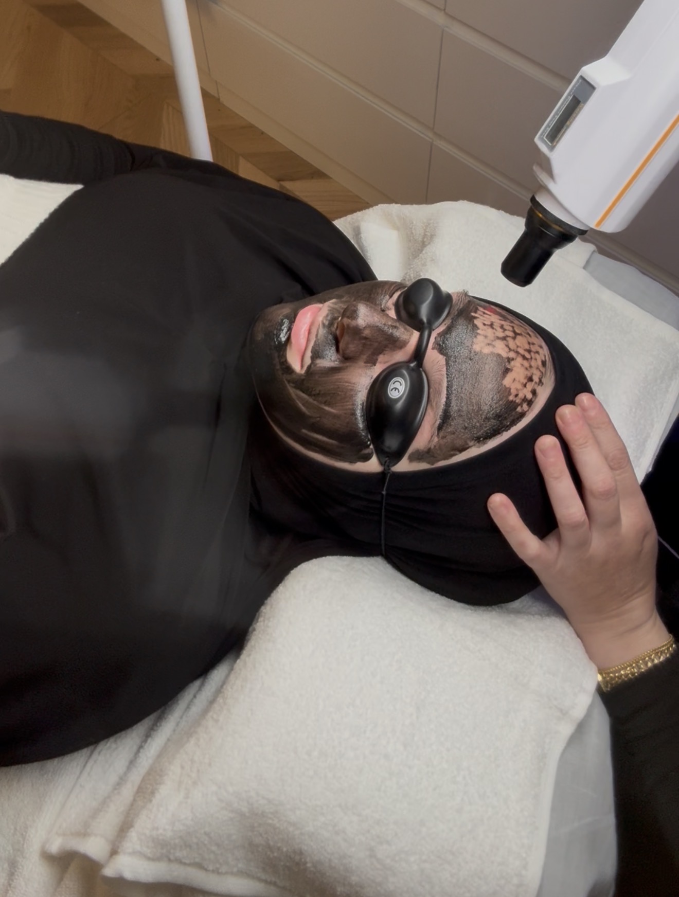 Client receiving a carbon facial treatment at Alura Skin Studio